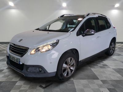 the small white car is parked in a large room