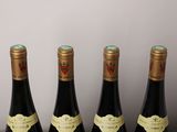 three bottles of wine are lined up on a table
