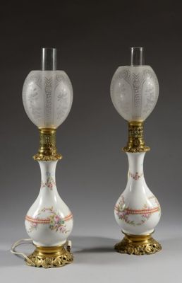 pair of white and gold vases with floral designs on them