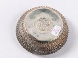 a silver plate with a crown on it on a white surface