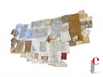 a pile of old maps on a white surface
