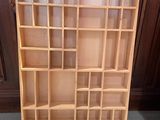 a wooden book shelf with many shelves on it