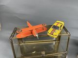 two toy airplanes sitting on top of a glass display case