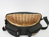 a wicker basket in the back of a black bag