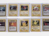 several pokemon cards are arranged in a row on a white surface