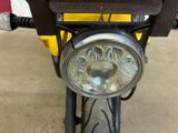 a close up of a motorcycle with a headlight on