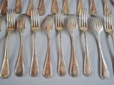 a lot of forks and spoons that are on the table