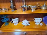 a wooden cabinet with a bunch of tea cups and saucers on it