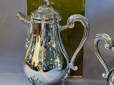pair of antique silver plated teapots and saucers