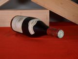 a bottle of wine sitting on a table next to a wooden box