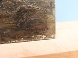 a close up of a wooden box with a painting on it