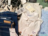 a lot of clothes that are sitting on a table