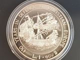 une image représentant une pièce d'argent sur laquelle figure l'effigie d'un navire