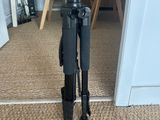 a tripod that is sitting on the floor in front of a door