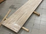 a wooden bench that is laying on the floor in a room