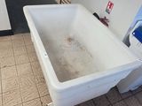 a bathtub in the middle of a tiled floor in a bathroom