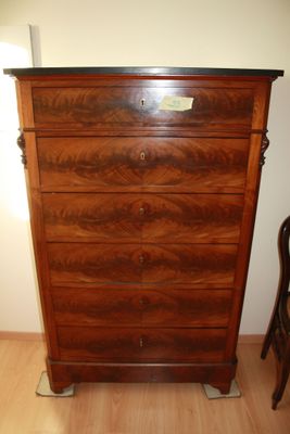 an image of a dresser in a room with a chair