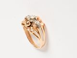 an image of a gold and diamond ring on a white surface