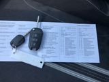 a car key sitting on top of a piece of paper next to a car key