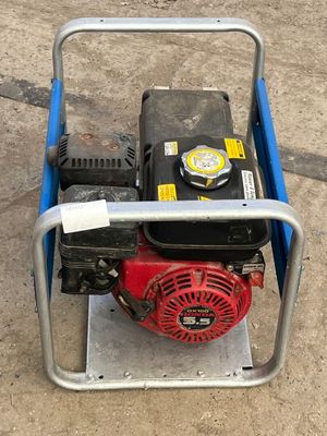 a small red and black engine on a blue cart
