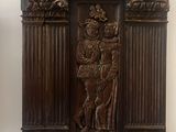 a statue of a man and a woman on a wall
