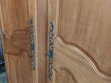 an image of a wooden armoire in a room