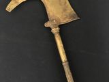 an old axe with a wooden handle on a black surface