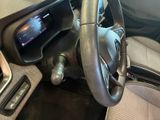 a car dashboard with a steering wheel and a dash button