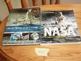 two books sitting on top of a wooden table next to each other