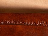 brown leather case with a name engraved on the inside of it