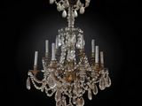 a large crystal chandelier hanging from the ceiling in a dark room
