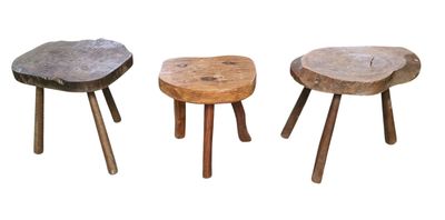 three wooden stools sitting next to each other on a white surface