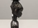 an image of a sculpture of a woman with a cat on her head