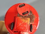 a person holding a red fire hydrant in their hand