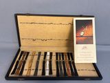 a box with a set of pens and a card in it