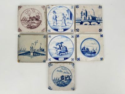 several blue and white tiles with pictures of people on them