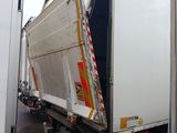 a large white truck with a red stripe on the back of it