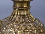 a gold vase with a flower decoration on it