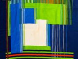 une image représentant une couette en patchwork bleue et verte