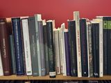 many books that are on a book shelf in the room