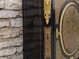 a black and gold cabinet with a door on it