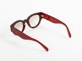 the glasses are made of wood and have a red frame