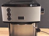 an image of a coffee maker on a wooden table