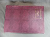 a pink book sitting on top of a white cloth covered table