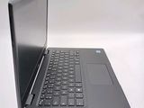 a laptop computer sitting on a table with a keyboard