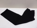 the leggings of a pair of black pants are on a white surface