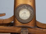 an old fashioned scale with a clock on top of it