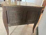 a wooden table with a marble top in a room