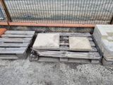 a pile of pallets sitting on the ground next to a fence