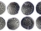 six ancient silver coins with designs on them on a white surface